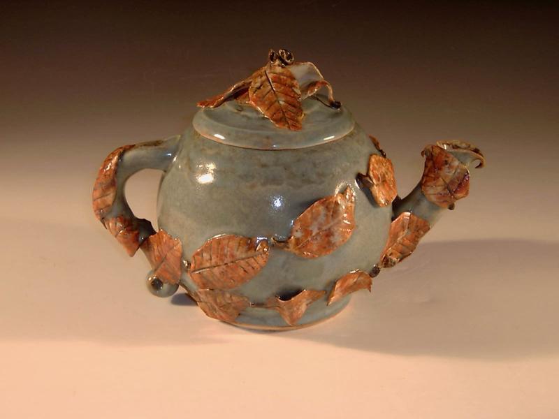 Handmade teapot with leaves